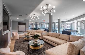 a living room with couches and chairs and a table